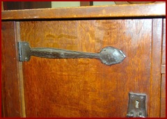 Close-up of door on left side showing the hand hammered copper strap hinge.